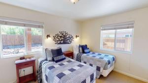 a bedroom with two beds and two windows at Leisure Space #327 in Moab