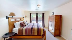 a bedroom with a bed and a table and a dresser at Leisure Space #327 in Moab