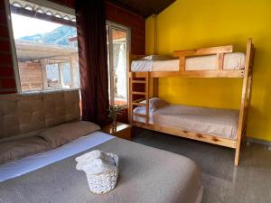a bedroom with two bunk beds and a window at Anagrama house in Baños