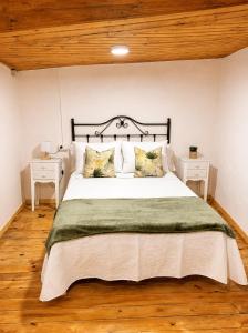 a bedroom with a large bed and two night stands at Casa Portos in Lestedo
