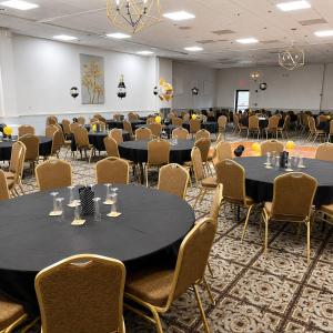 a conference room with tables and chairs and a podium at Quality Inn & Suites in Williamsburg +51 photos