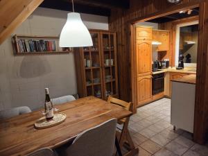 a dining room with a table and a bottle of wine at Ferienhaus Fuchsbau in Extertal