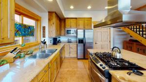 a kitchen with a stove and a refrigerator at Rim View Retreat #14 in Moab