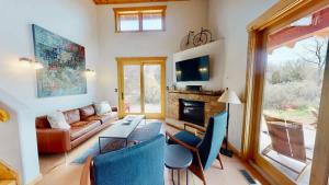 a living room with a couch and a fireplace at Rim View Retreat #14 in Moab