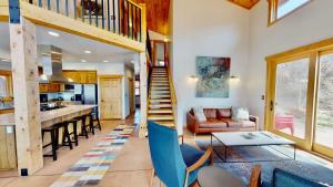 a kitchen and living room with a staircase and a living room at Rim View Retreat #14 in Moab +32 photos