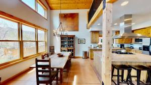 a kitchen with a wooden table and a dining room at Rim View Retreat #14 in Moab