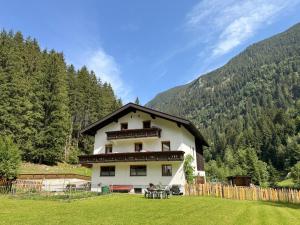 a house in the middle of a field with trees at Haus Sauberbach in Jerzens