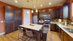 a kitchen with wooden cabinets and a white counter top at Entrada at Moab #640 in Moab