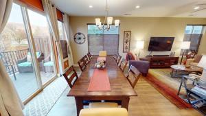 a dining room with a table and a living room at Entrada at Moab #640 in Moab