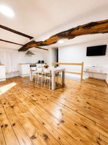 a kitchen and dining room with a wooden floor at Casa Portos in Lestedo +14 photos