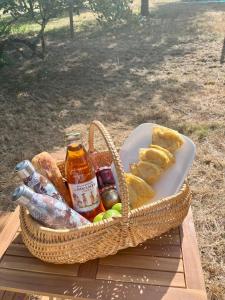 a basket of food and bread on a picnic table at La caravane dans le verger in Saint-Erblon +6 photos