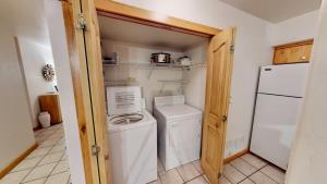 a small laundry room with a washer and dryer at The Rock #3461 in Moab +31 photos