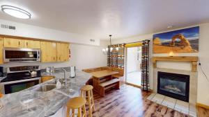a kitchen with a fireplace and a table and chairs at The Rock #3461 in Moab