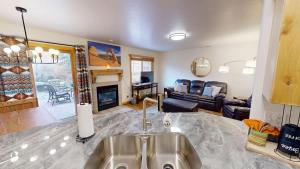 a kitchen with a sink and a living room at The Rock #3461 in Moab