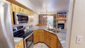 a kitchen with a sink and a stove top oven at The Rock #3461 in Moab