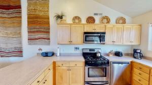 a kitchen with wooden cabinets and a stove top oven at Desert Hideaway #C2 in Moab