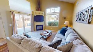 a living room with a couch and a table at Desert Hideaway #C2 in Moab +27 photos