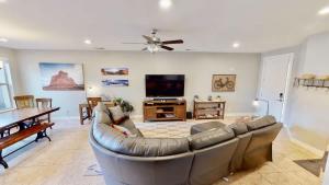 a living room with a couch and a flat screen tv at Entrada at Moab #668 in Moab