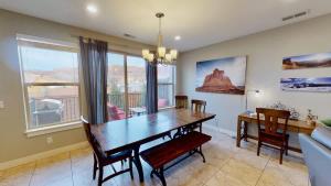 a dining room with a table and a couch at Entrada at Moab #668 in Moab