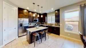 a kitchen with a island with bar stools at Entrada at Moab #668 in Moab