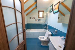 a bathroom with a toilet and a sink at SeviCris in Lissa +91 photos
