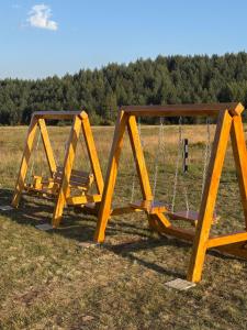 a swing set sitting in the middle of a field at Zabljak villa VAM in Žabljak +32 photos