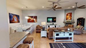 a living room with couches and a dining room at Adventure Base Camp #381 in Moab