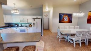 a kitchen and dining room with a table and chairs at Adventure Base Camp #381 in Moab