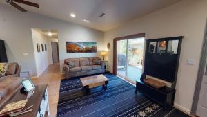 a living room with a couch and a table at Adventure Base Camp #381 in Moab