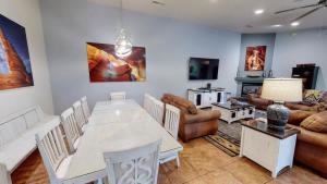 a living room with a table and chairs and a couch at Adventure Base Camp #381 in Moab +17 photos