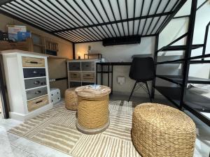 a living room with a table and some chairs at Le Refuge in Margencel