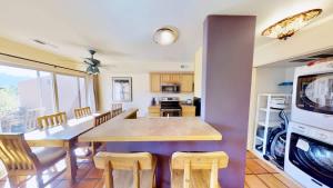 a kitchen and dining room with a table and chairs at Sunset View #3234 in Moab