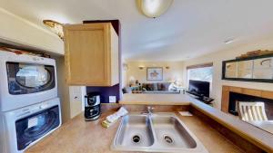 a kitchen with a sink and a living room at Sunset View #3234 in Moab