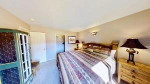 a bedroom with a bed and a lamp on a dresser at Sunset View #3234 in Moab +15 photos