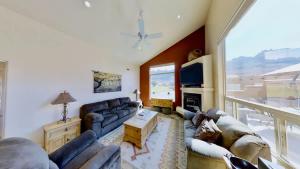 a living room with a couch and a tv at Grey Pearl #Q3 in Moab