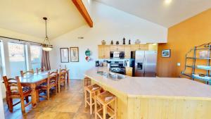 a kitchen with a table and some chairs and a counter at Arches Abode #A3 in Moab