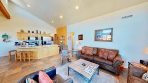 a living room with a couch and a table at Arches Abode #A3 in Moab