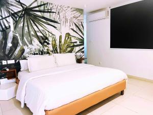 a bedroom with a large bed and a tv at Ganalé Hôtel in Dakar