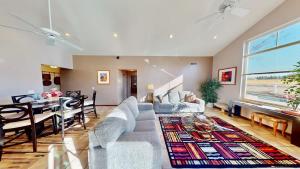 a living room with a couch and a dining room at Mountain Paradise #G3 in Moab