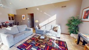 a living room with two couches and a table at Mountain Paradise #G3 in Moab