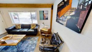 a living room with a couch and a table and chairs at Moab Flats #3 in Moab