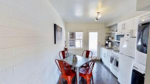 a kitchen with a table and red chairs in it at Moab Flats #3 in Moab