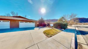 a house with two garage doors and a driveway at Portal Vista #443 in Moab