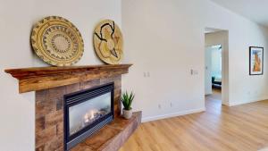 a living room with a fireplace and a plate on the wall at Portal Vista #443 in Moab +40 photos