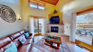 a living room with a couch and a fireplace at Coyote Run #4 in Moab