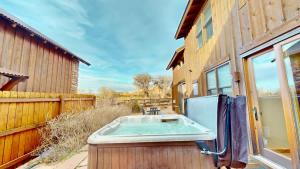 a hot tub sitting next to a building at Coyote Run #4 in Moab