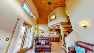 a living room with a couch and a ceiling fan at Coyote Run #4 in Moab