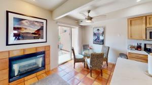 a living room with a fireplace and a table and chairs at Henning's Escape #3328 in Moab