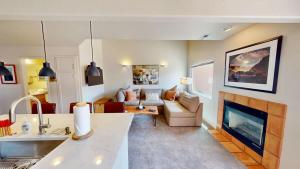 a living room with a couch and a fireplace at Henning's Escape #3328 in Moab