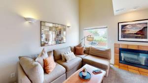 a living room with a couch and a fireplace at Henning's Escape #3328 in Moab